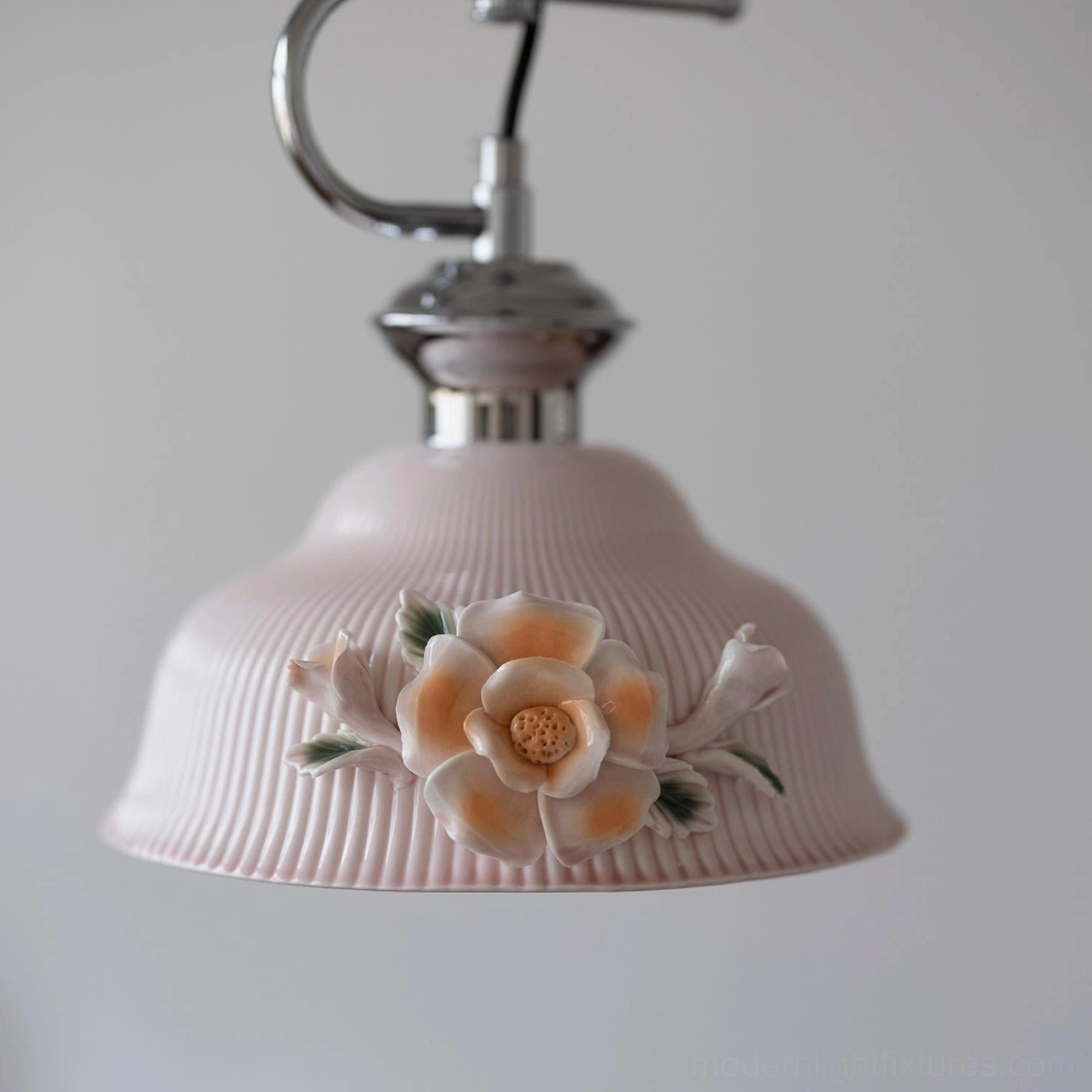 Evelisse ceramic pendant light artistic installation showing sculptural camellia ornament and contemporary chrome hardware