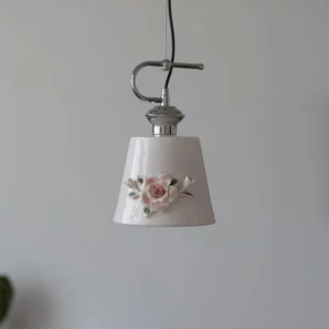 Evelisse blush pink ceramic pendant fixture with hand-crafted rose ornament and silver metal components, modern minimalist interior setting