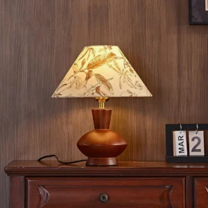 Evie beige floral pattern fabric shade table lamp on wooden dresser - warm ambient bedside lighting with vintage decor
