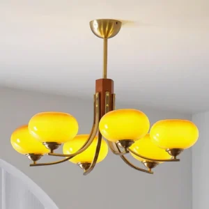 Illuminated Fabio 6-head chandelier showing warm glowing amber glass globe lighting effect