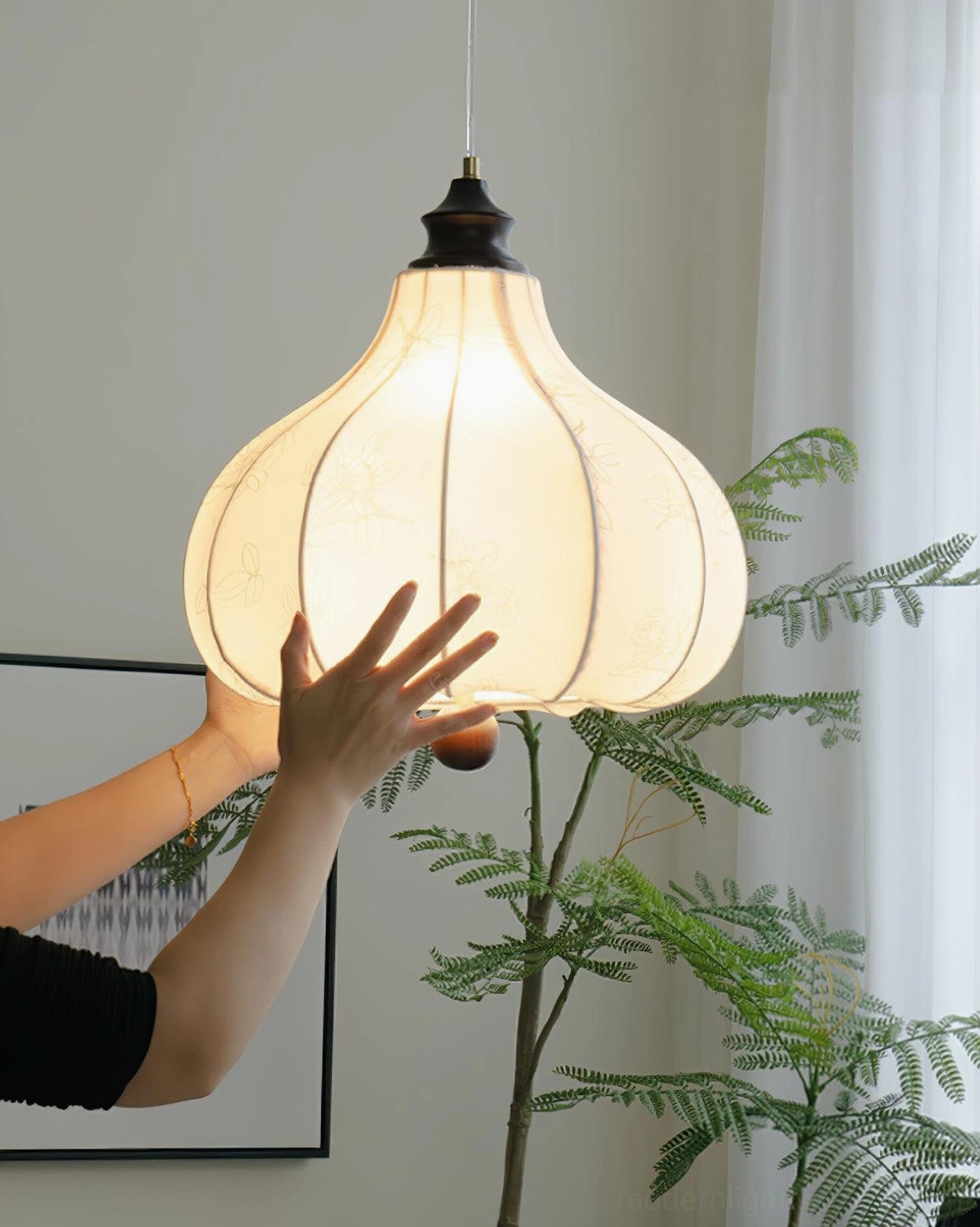 Fabric lantern pendant with cream shade and dark wood accents, close-up side angle showing botanical details and brass hardware