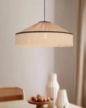 Beige fabric fringe pendant lamp hanging in modern dining corner with warm bohemian aesthetic and neutral decor