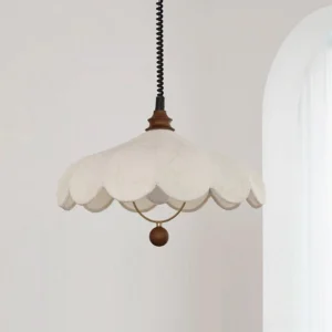 Modern hanging lamp with patterned fabric shade and decorative metal finial, three-quarter angle