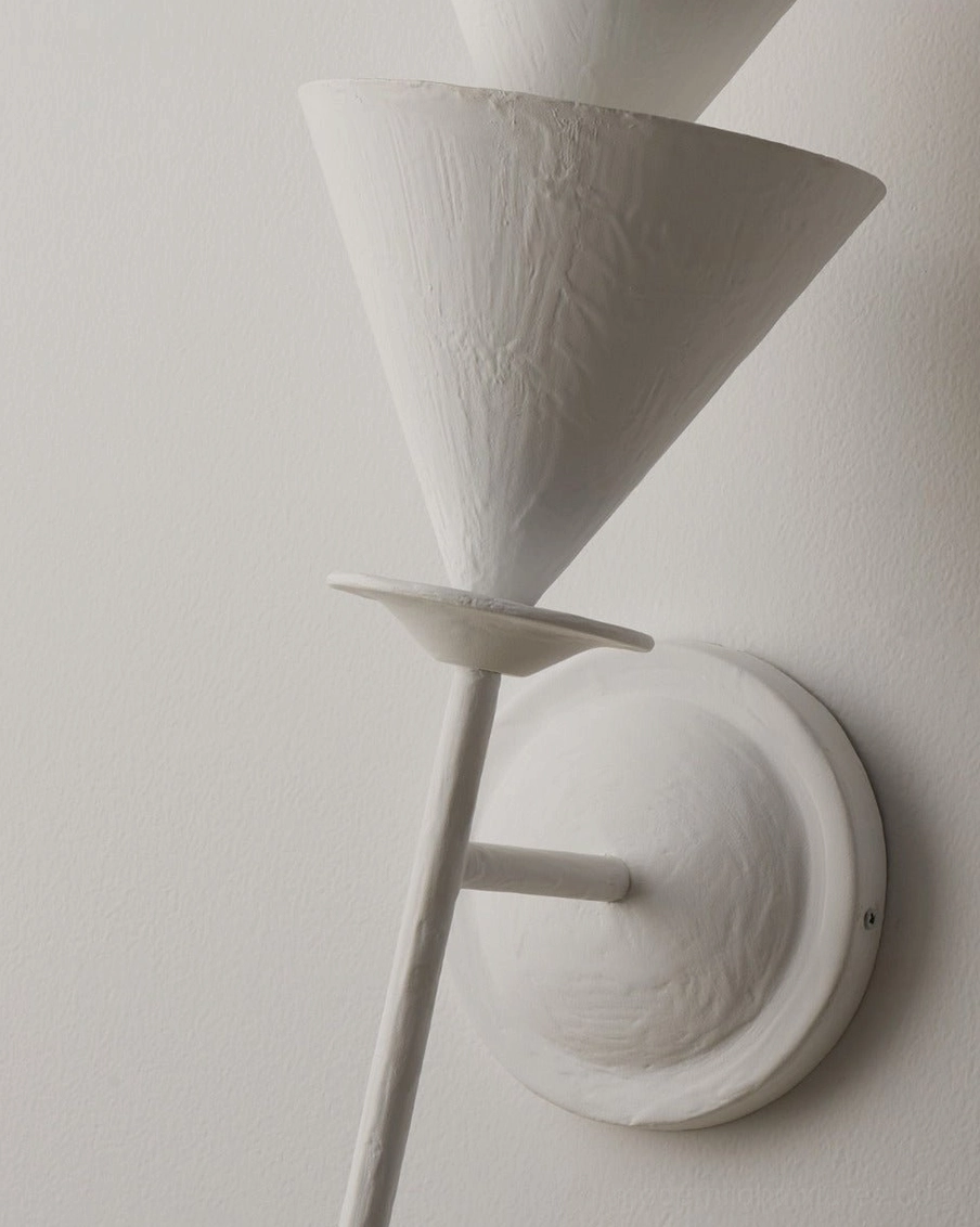 Fanoria modern sculptural wall sconce close-up showing textured plaster-like resin finish and cone geometry design