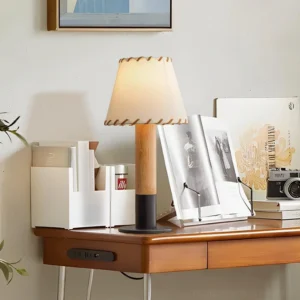 Rustic wood table lamp with hand-stitched fabric shade displayed on home office desk with warm ambient lighting