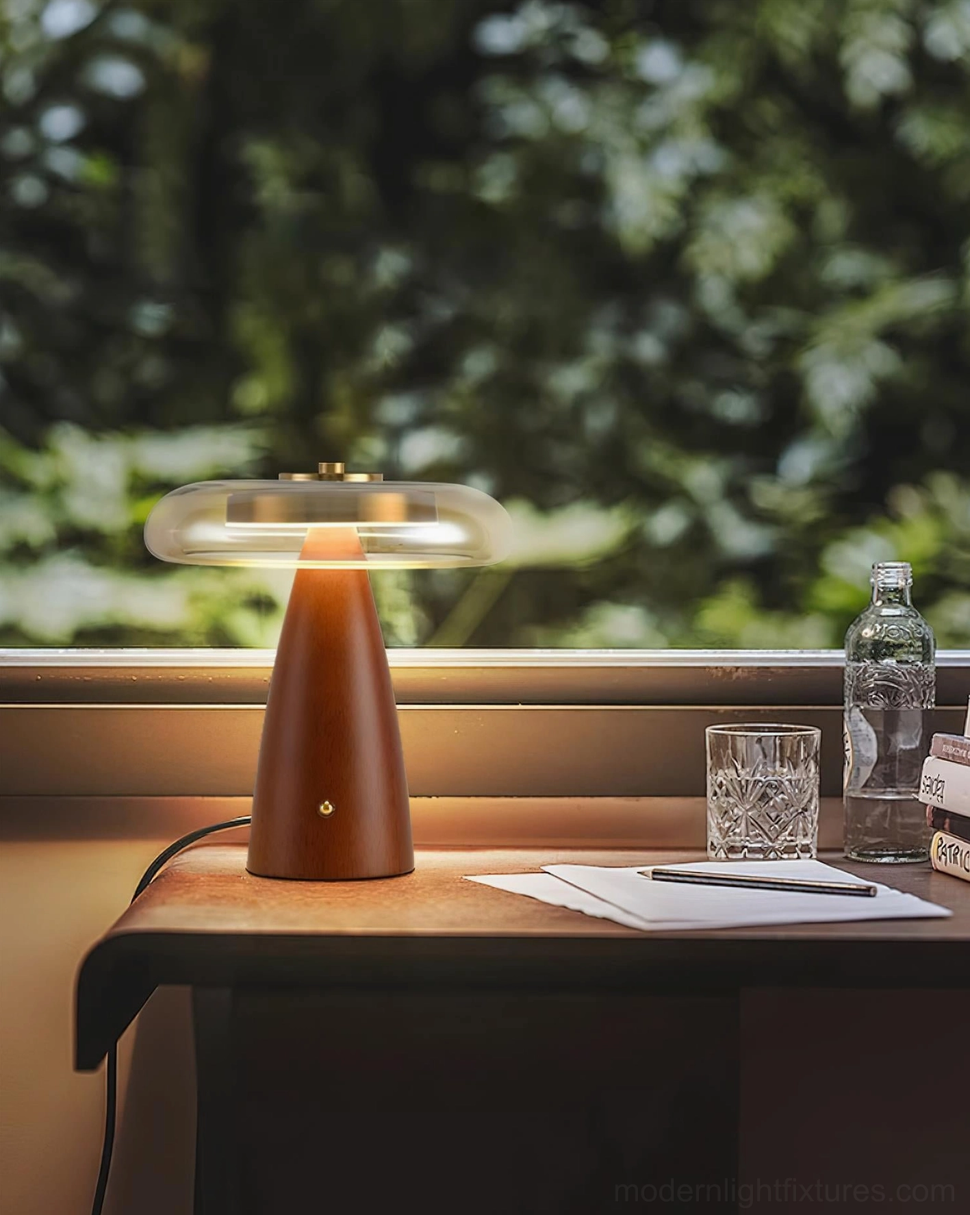 Fathom modern desk lamp by window in home office with natural light and office accessories