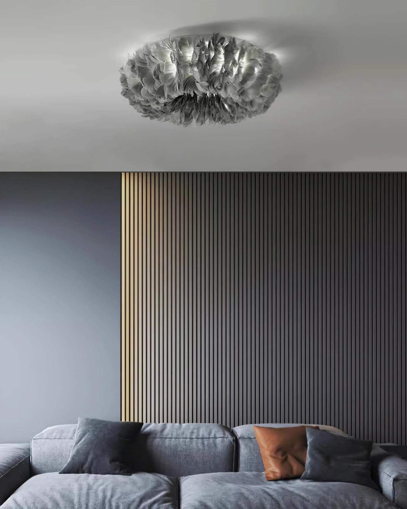 Gray feather ceiling light fixture hanging in modern living room with gray sofa, showing gunmetal gray clustered feather design