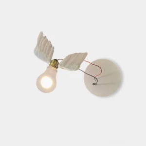 Feathered wing wall sconce with white resin wings and brass accents on white background, front view showing artistic design