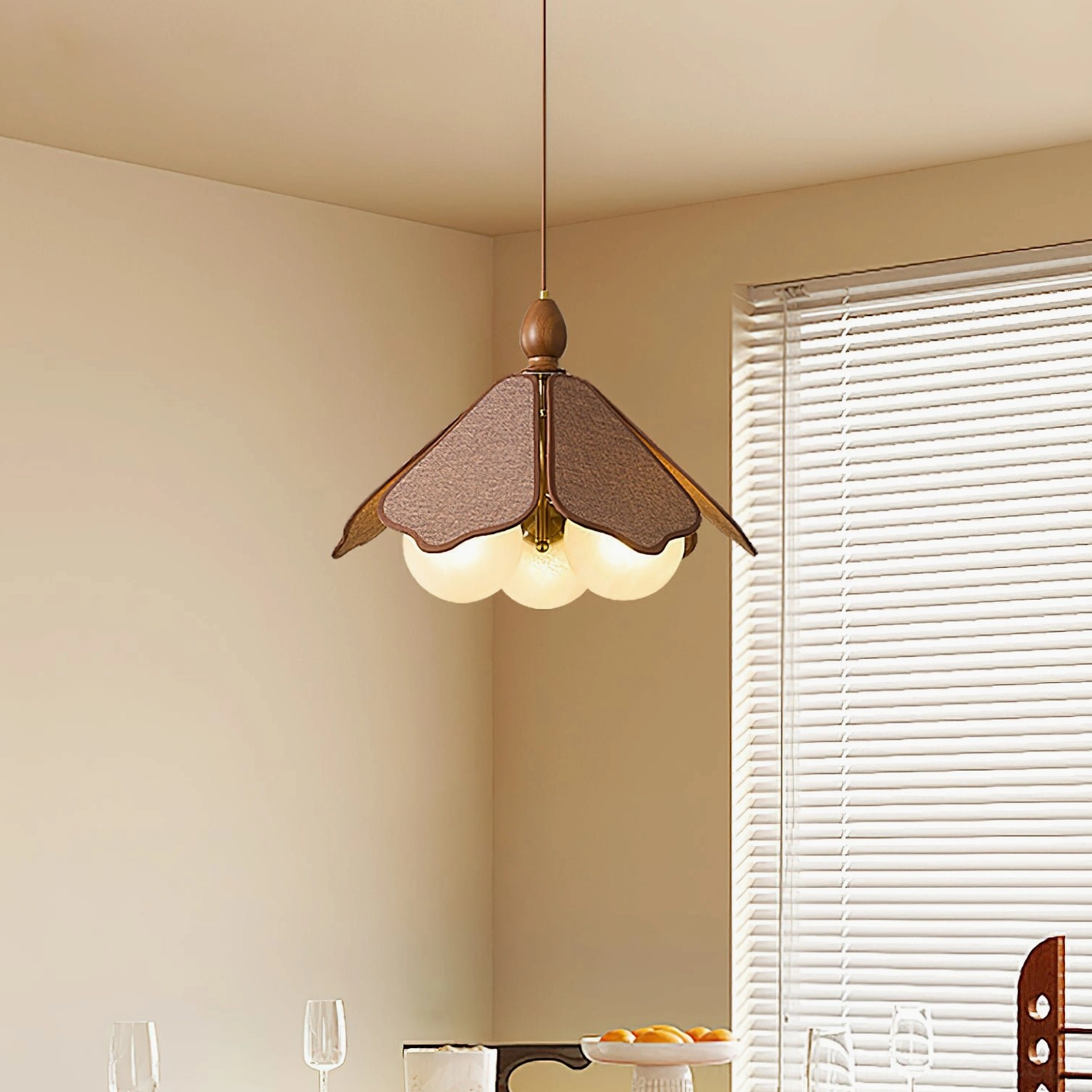 Feyora modern glass pendant light with glowing frosted bulbs in dining area with window blinds