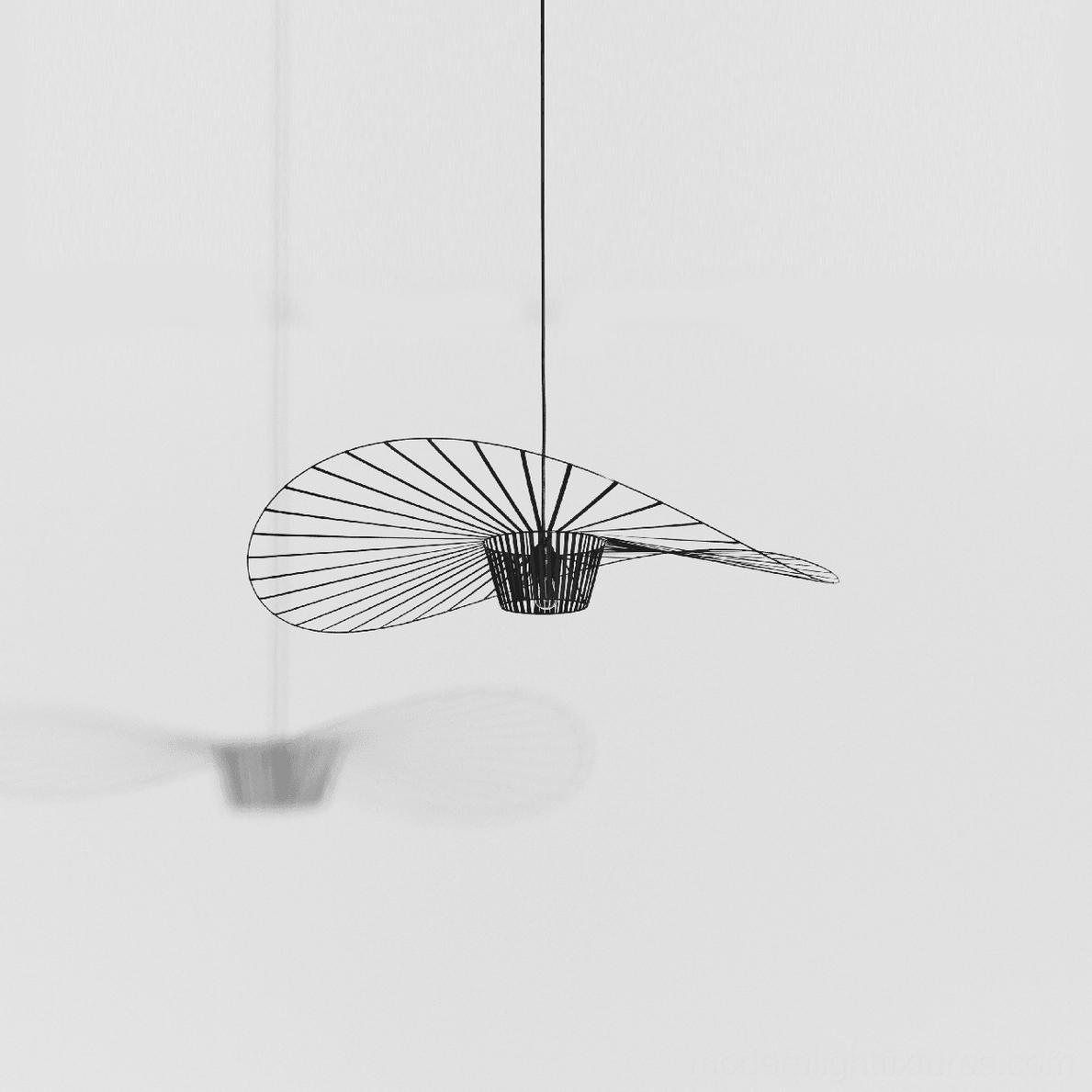 Woven fiber glass pendant lamp above seating arrangement as visual organizing element