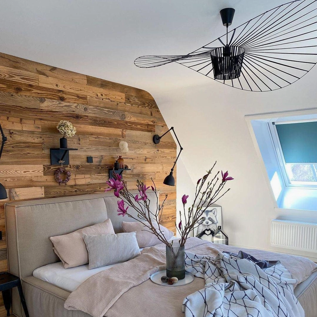 Woven fiber glass pendant lamp casting intricate shadow patterns on ceiling and walls at dusk