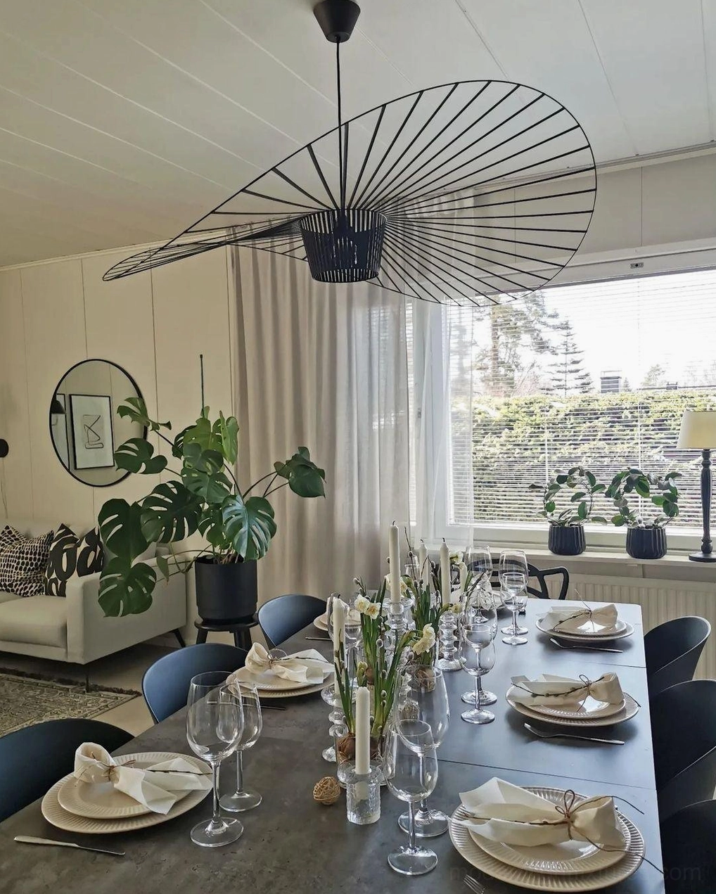 Woven fiber glass pendant as room's visual centerpiece with furniture arrangement