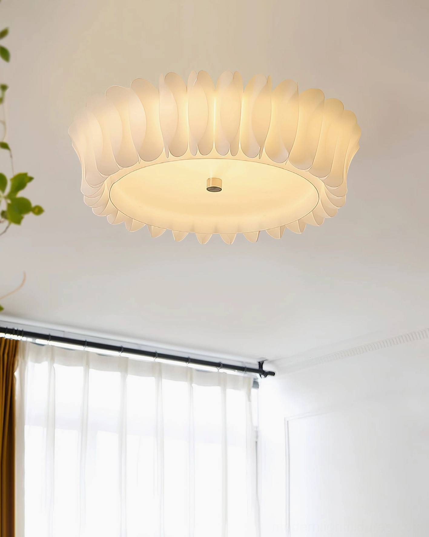 Ruffled ceiling light in minimalist room with sheer curtains, warm off-white petal design glowing softly