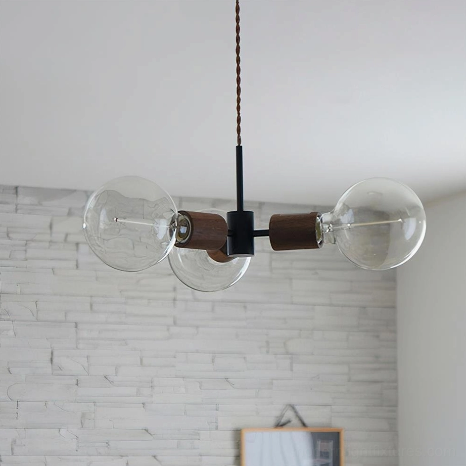 Filotto 3-head linear pendant light with clear glass globes and walnut wood fixtures in modern Nordic style room