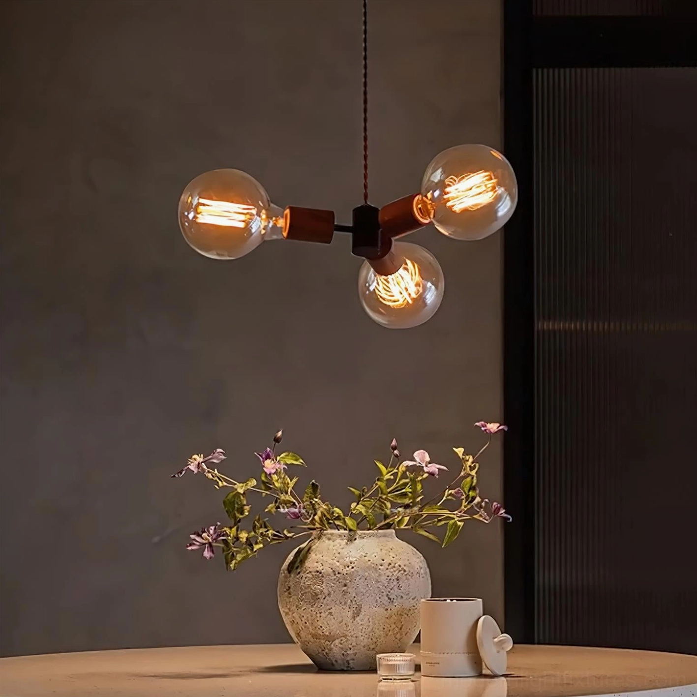Filotto pendant light with lit filament bulbs creating vintage rustic ambiance over dining table
