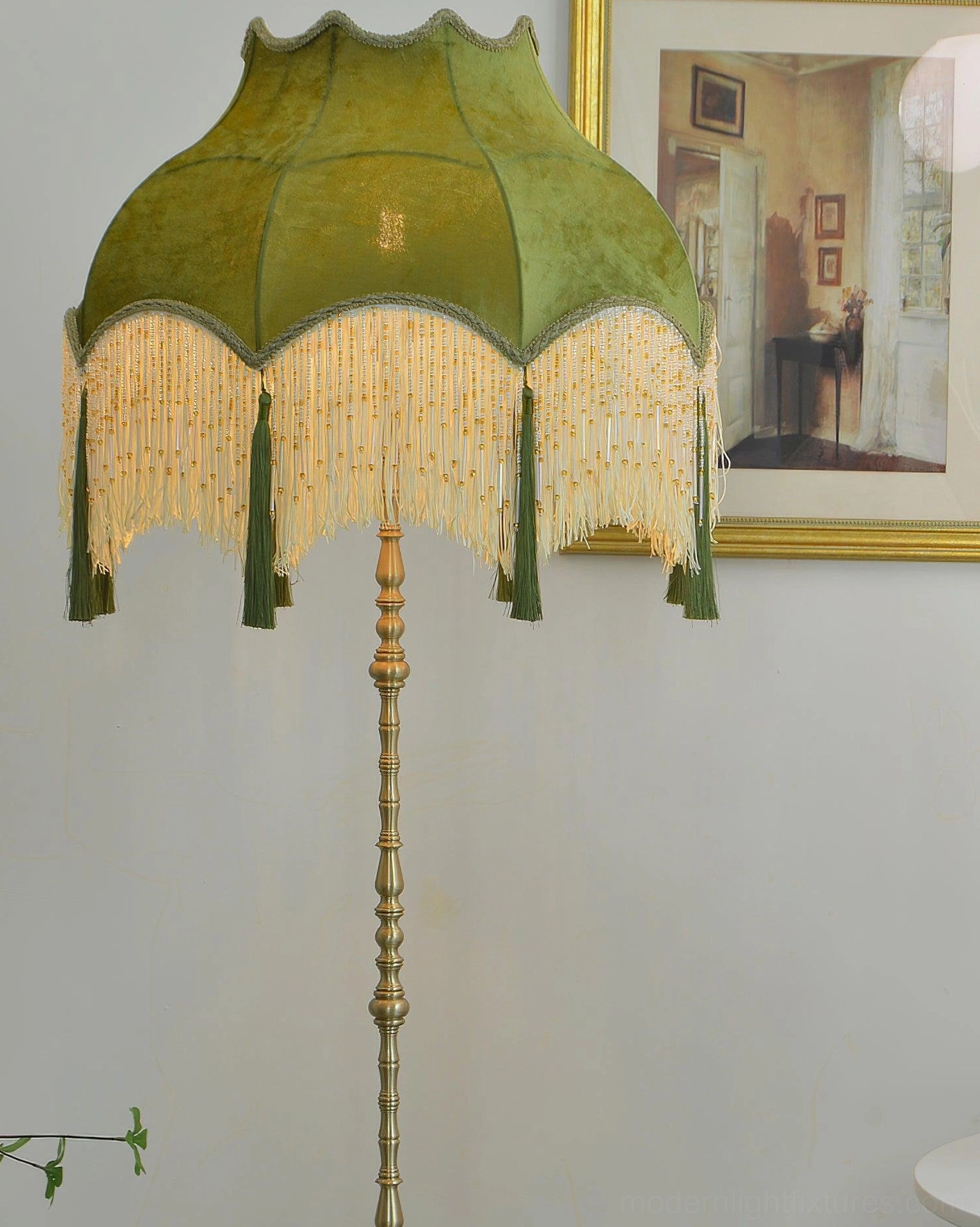 Close-up of Fina Tassel Floor Lamp green velvet shade with tassel trim and brass pole detail