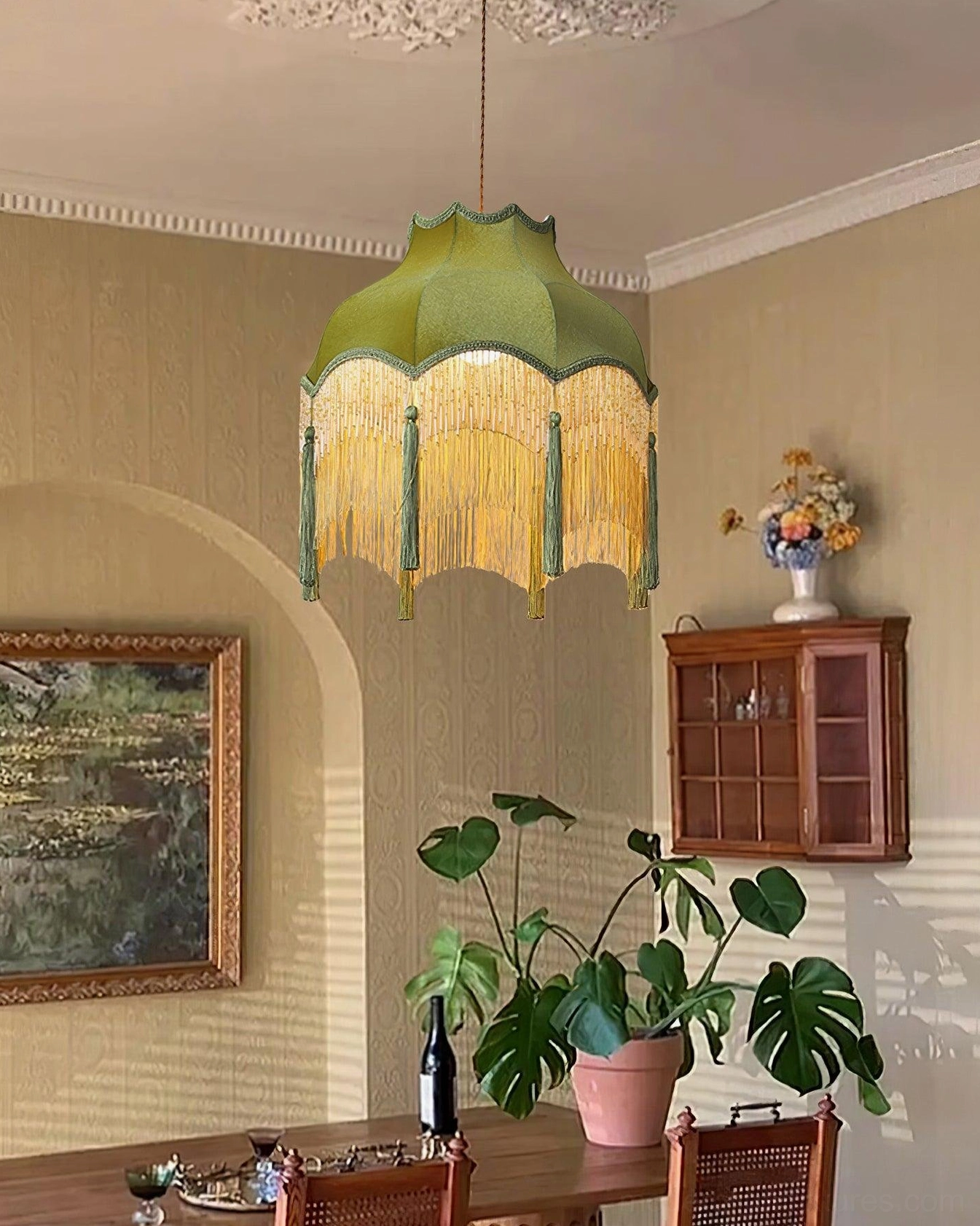 Fina brass and green velvet pendant hanging in vintage dining room with wooden furniture
