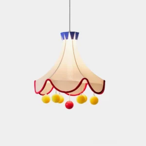 Finaflor circus tent pendant light close-up front view with beige fabric shade, red scalloped trim, blue crown top, and yellow pom-pom ball decorations isolated on white studio background
