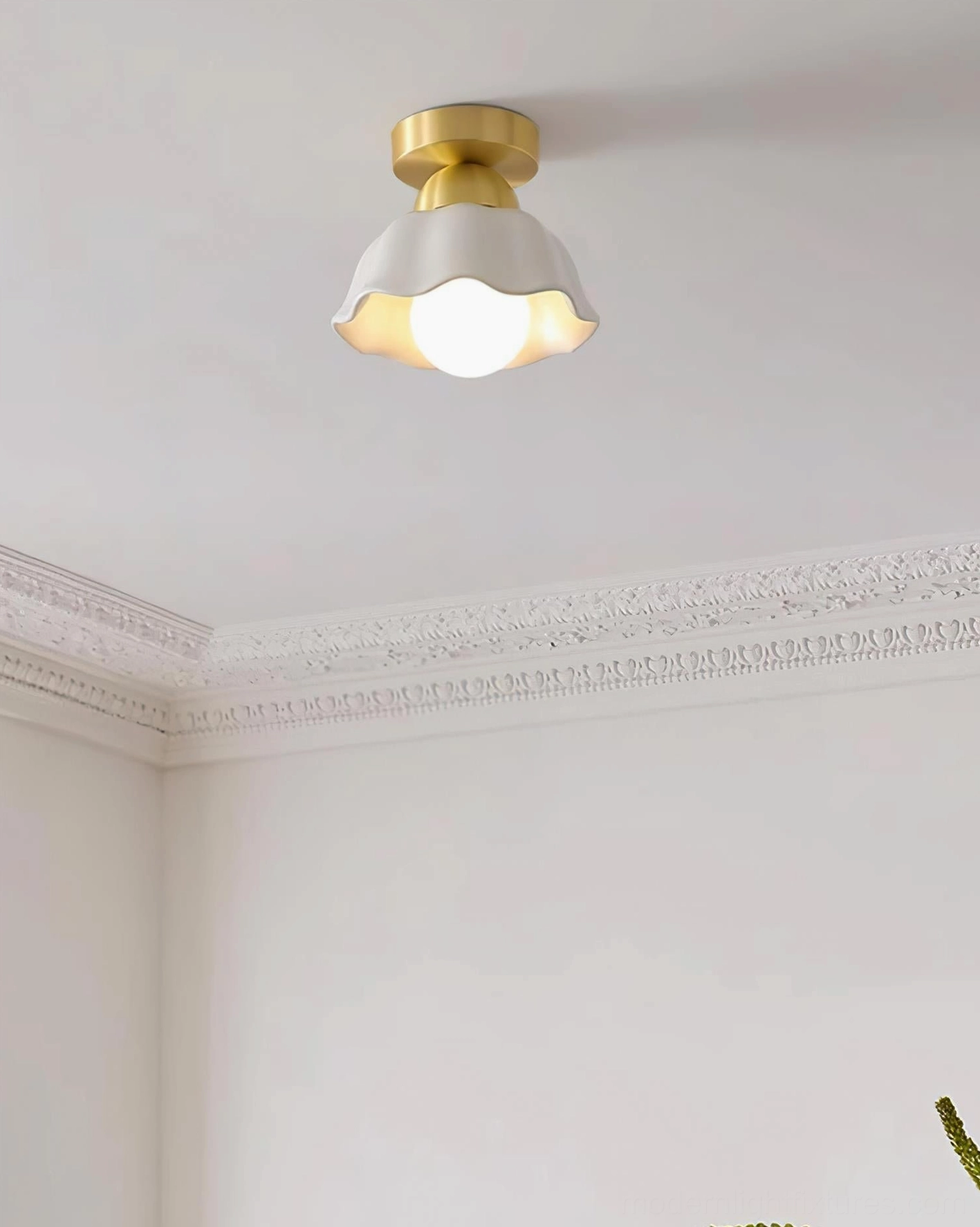 Finley brass ceiling light fixture in living room with crown molding and wall trim, modern organic lighting solution for contemporary interiors