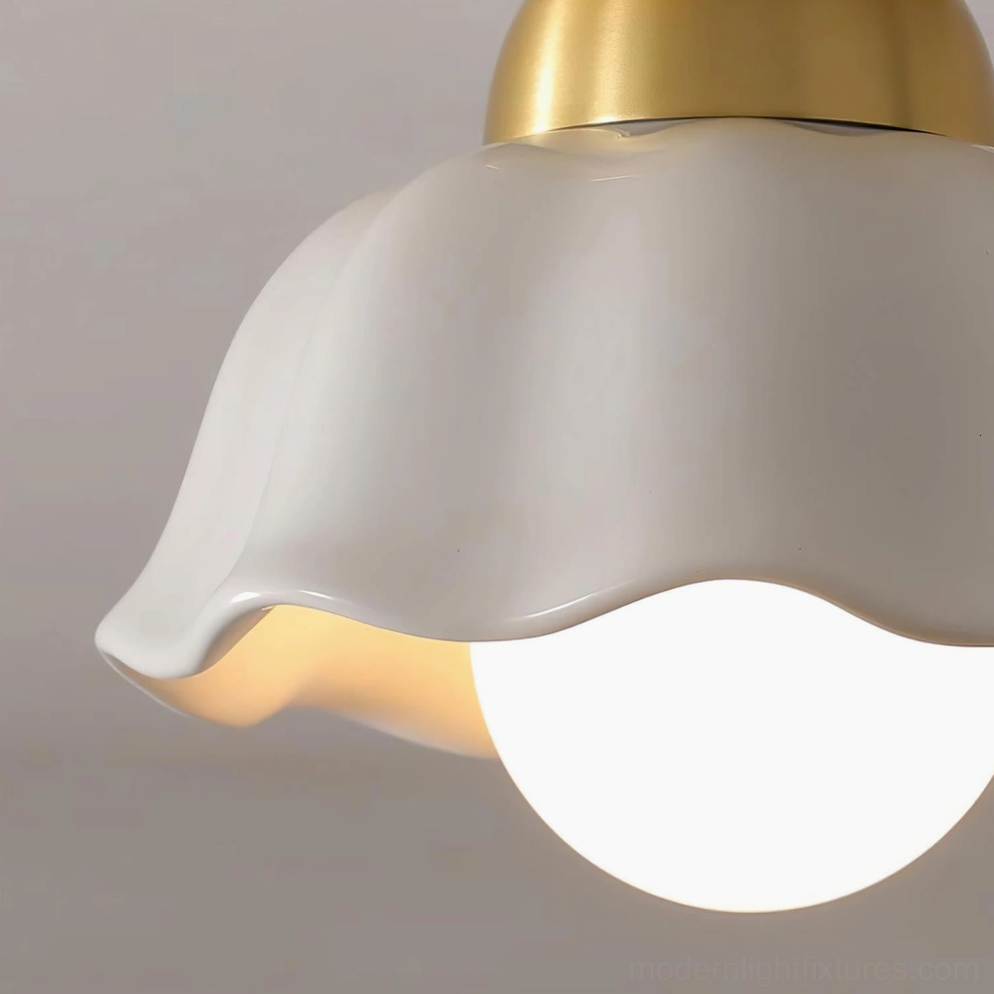 Finley handcrafted ceramic and brass ceiling lamp close-up, ruffled petal shade detail with brushed gold hardware finish