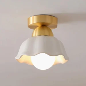 Finley brushed brass ceiling lamp with organic wavy ceramic shade, three-quarter angle showing sculptural petal-inspired design
