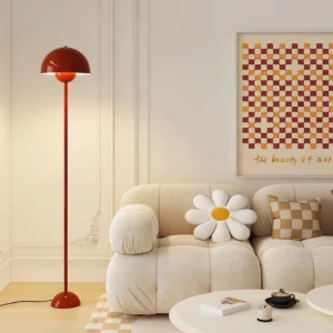 Burgundy mushroom floor lamp positioned in warm nordic living room next to fabric sofa and coffee table, three-quarter side view