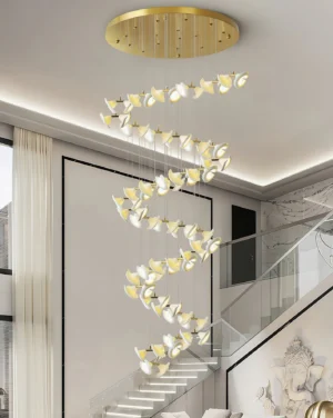 Fiora contemporary chandelier installed in duplex stairwell with cascading spiral design and warm lighting