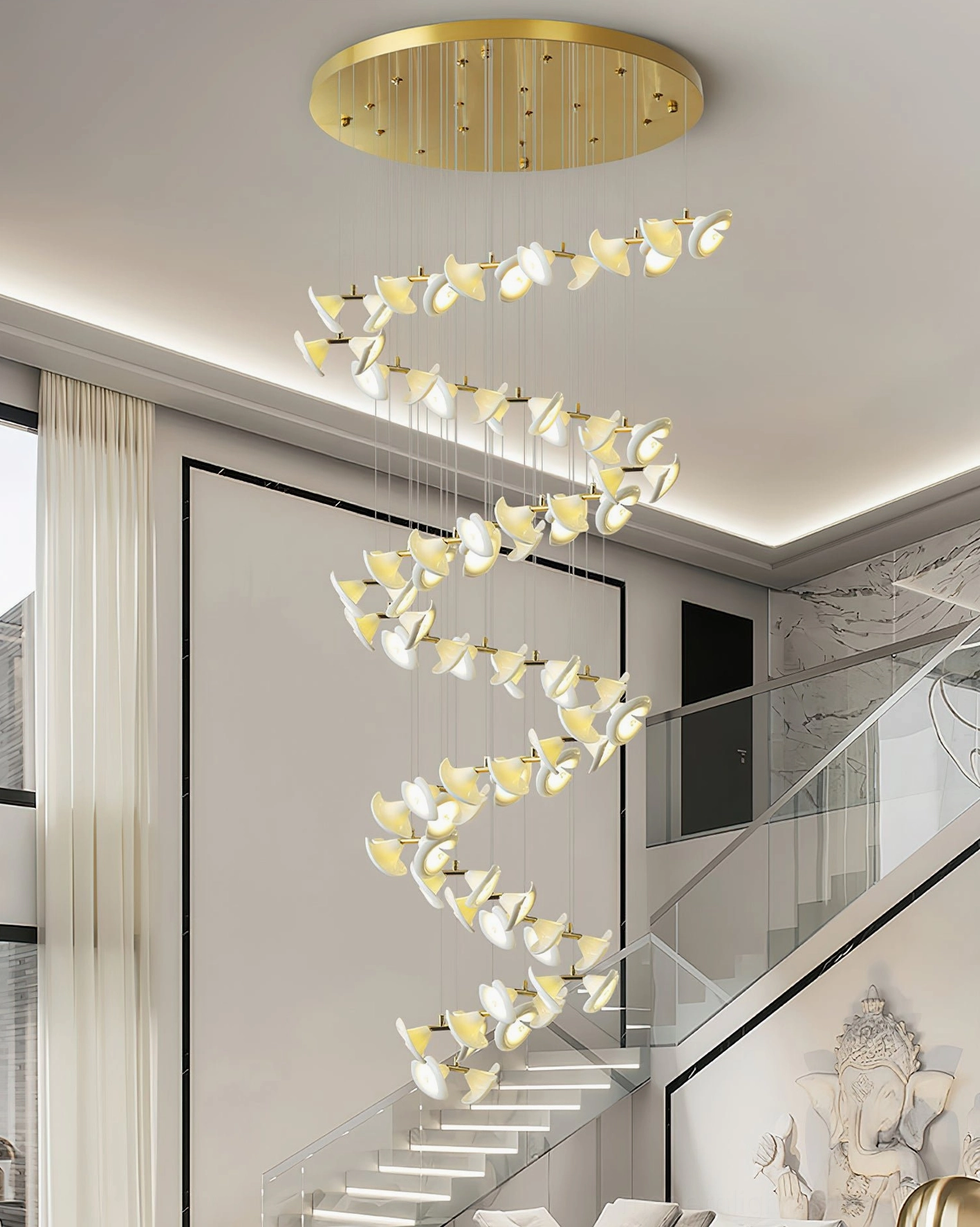 Fiora contemporary chandelier installed in duplex stairwell with cascading spiral design and warm lighting
