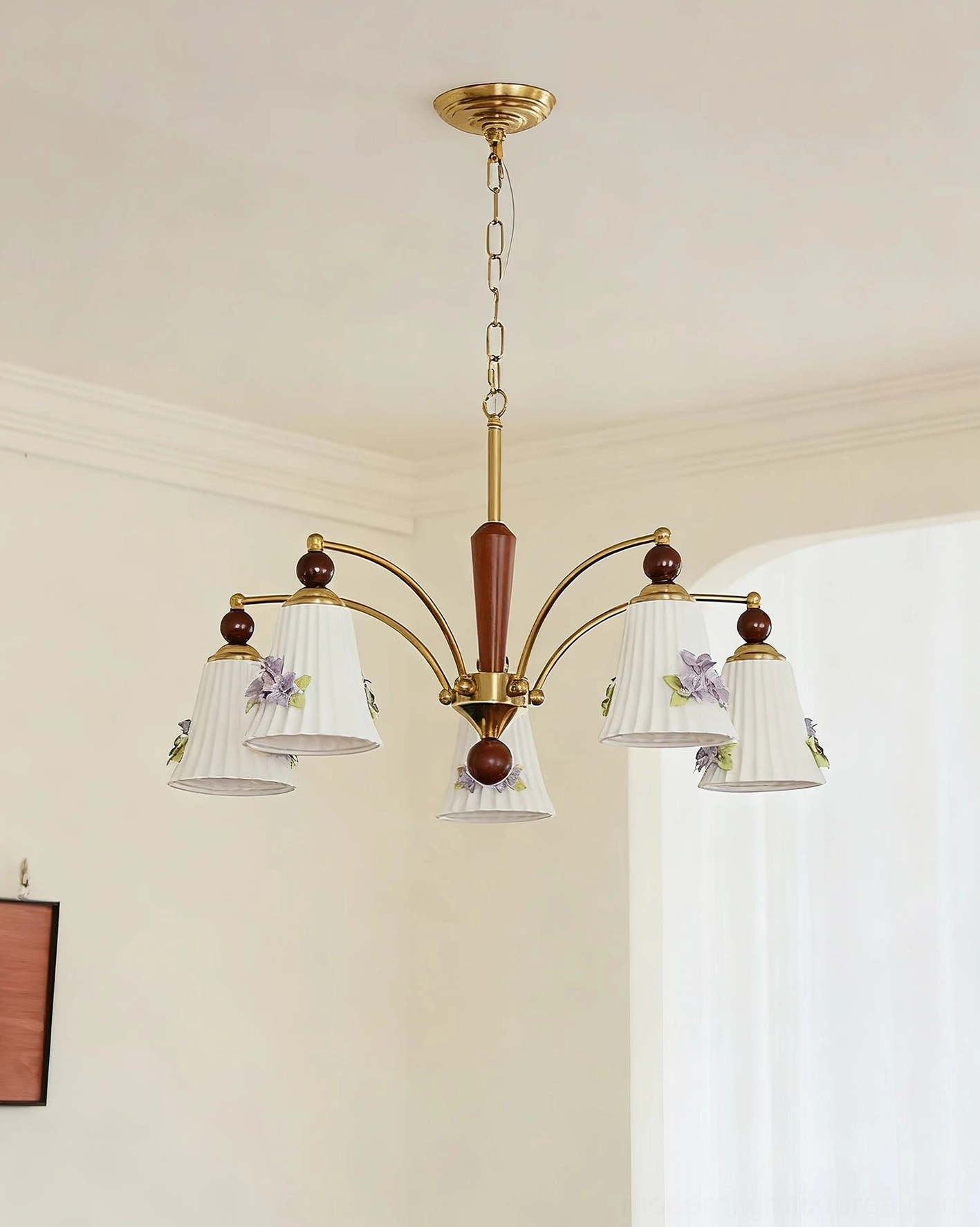 Fiorenta 5-head chandelier with brass metal frame and floral ceramic pleated shades in cream residential space
