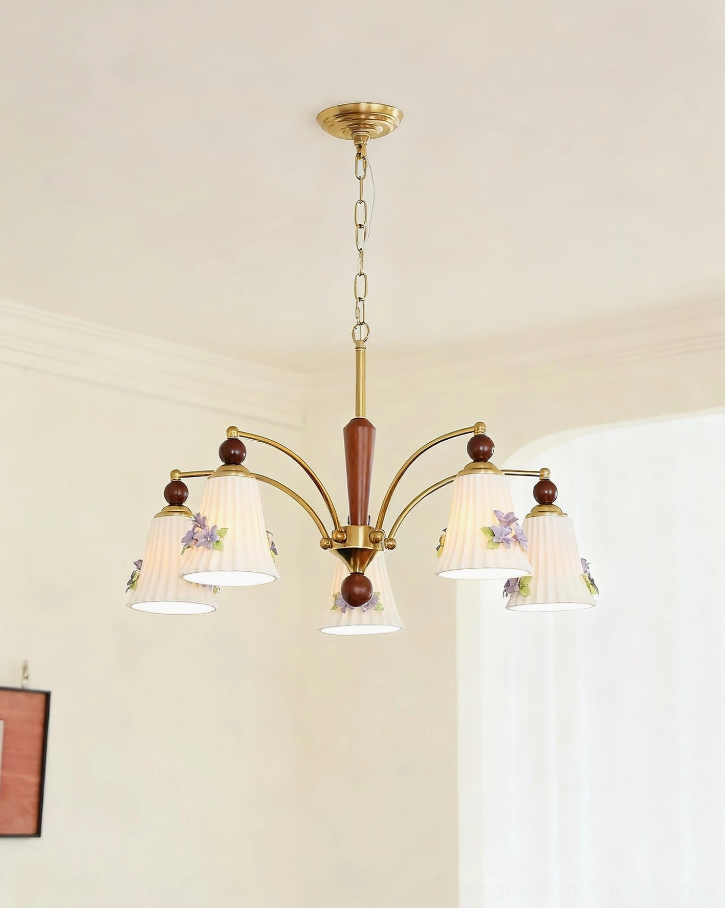 Front view of Fiorenta chandelier with brass metal frame and solid wood center post in minimalist living room