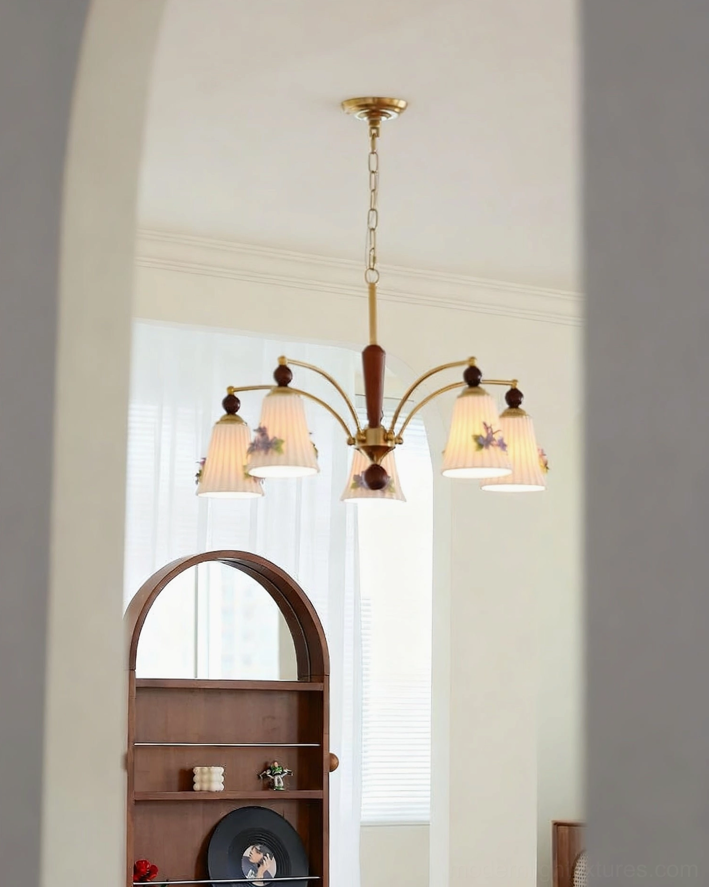 Fiorenta 5-light chandelier with plain ceramic pleated shades in vintage living room with arched decor shelf