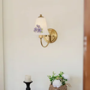 Fiorenta vintage wall lamp three-quarter view with curved brass arm and botanical floral decoration on pleated fabric