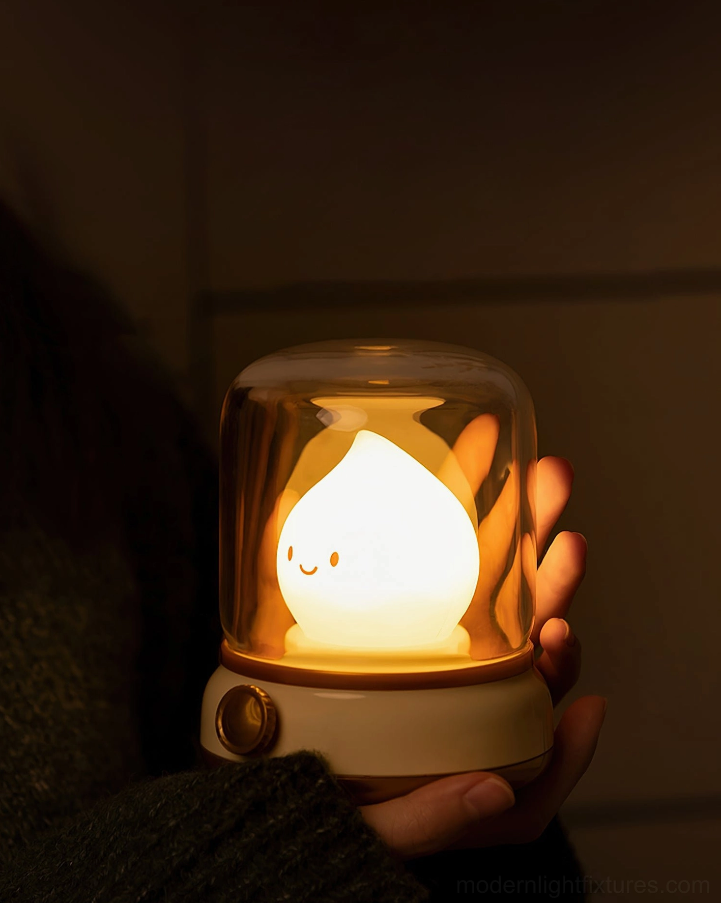 Flame LED small night light held in hands, off-white finish with gold trim, portable USB-rechargeable