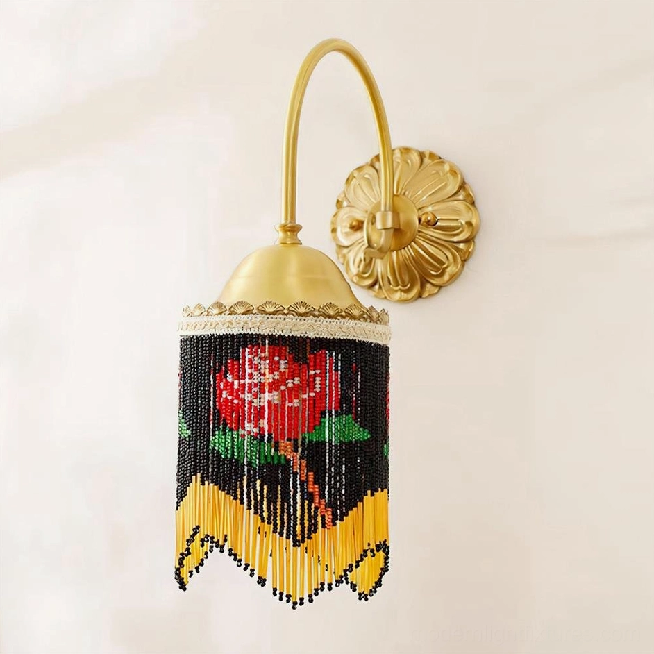 Black beaded wall lamp with brass curved arm and rose pattern close-up showing hand-strung bead details