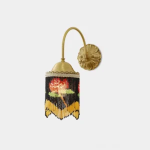 Flamenco rose beaded wall sconce with brass hardware and black beaded shade featuring red rose pattern in front studio view