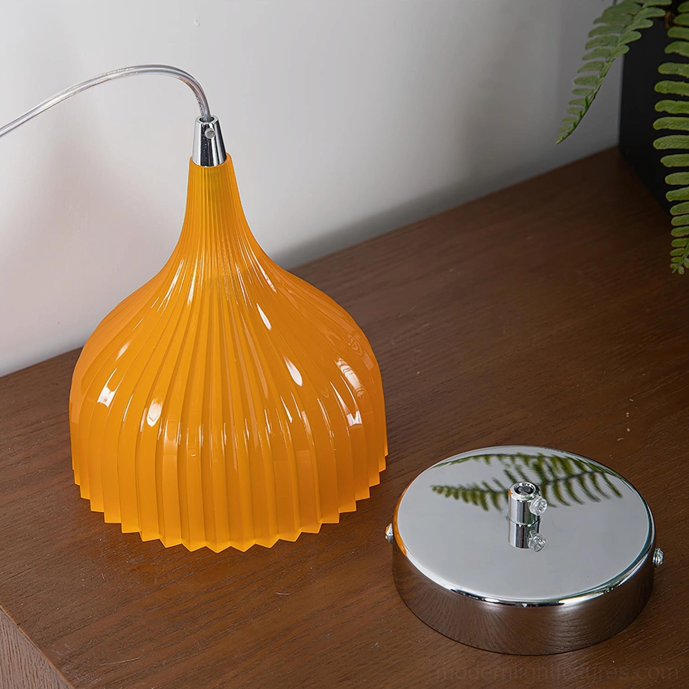 Single Flare amber ribbed pendant light creating warm glow over kitchen counter with breakfast bar seating