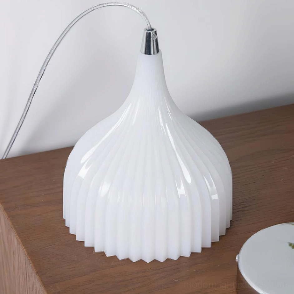 Flare white ribbed pendant light casting beautiful shadow patterns through vertical fluting in bright natural light