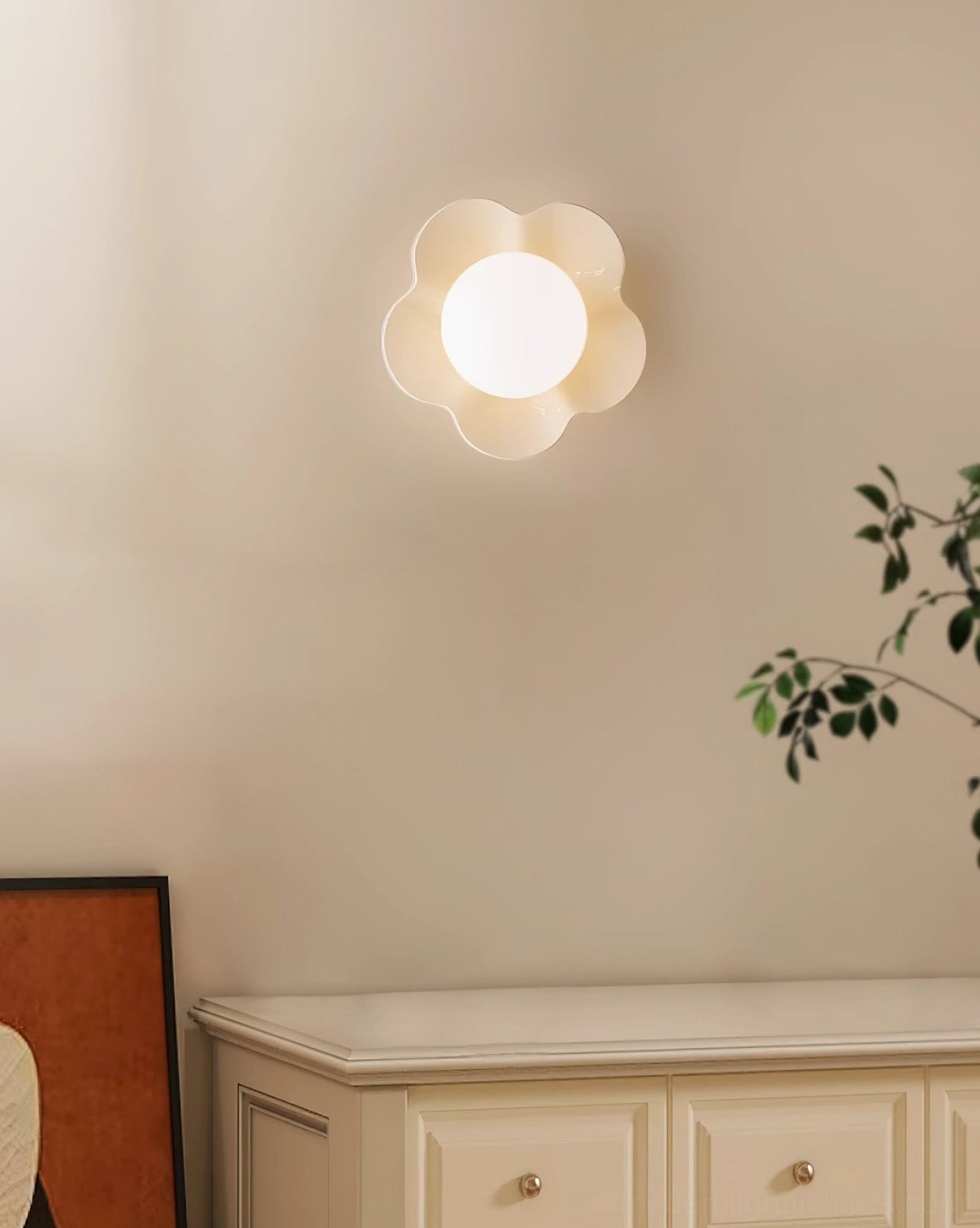 Fleur wall lamp positioned above bedroom dresser - small-scale sculptural flower sconce for intimate bedroom lighting