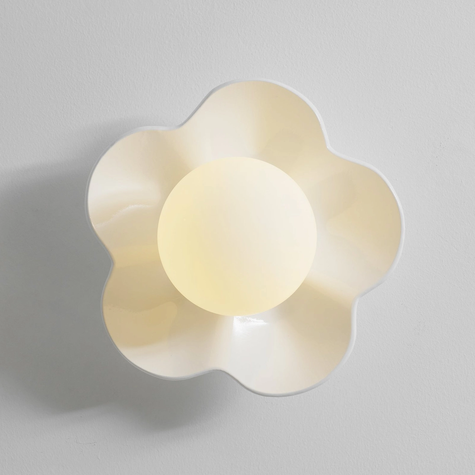 Fleur wall sconce array installation - multiple botanical lamps create distributed ambient lighting throughout space