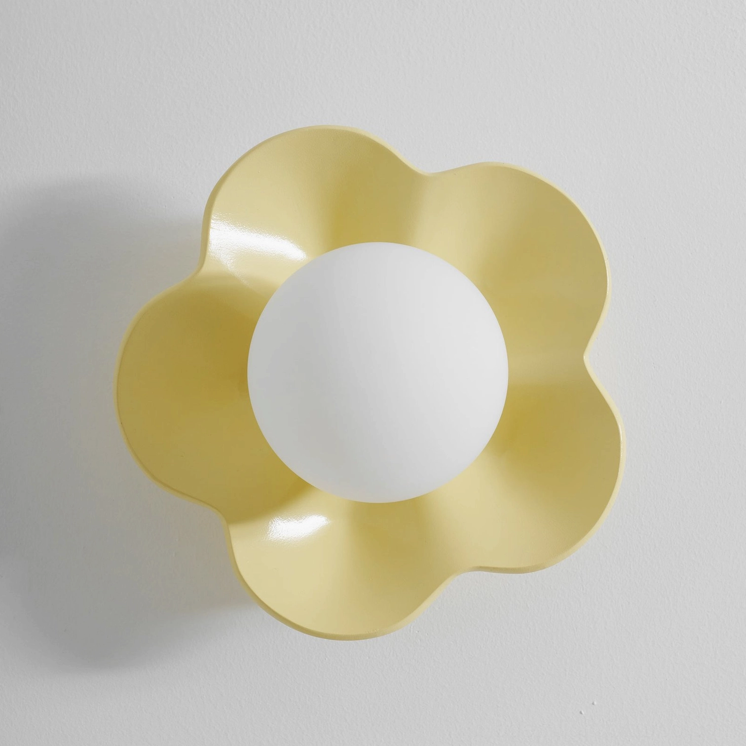 Fleur wall sconce softly glowing evening interior - botanical modern wall lamp creates intimate atmospheric ambiance