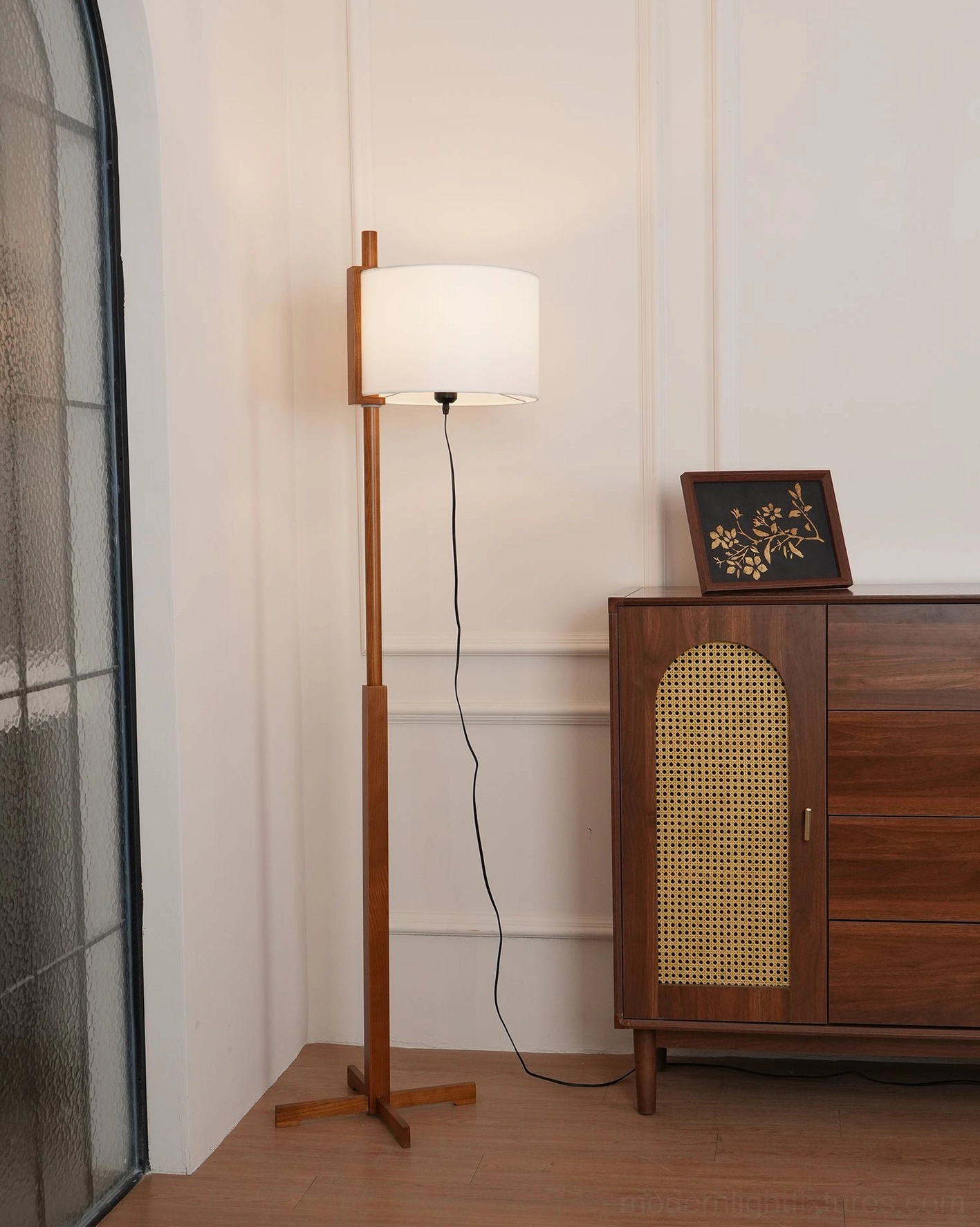 Floor lamp base and lower pole detail showcasing solid walnut wood construction and cross-shaped support structure