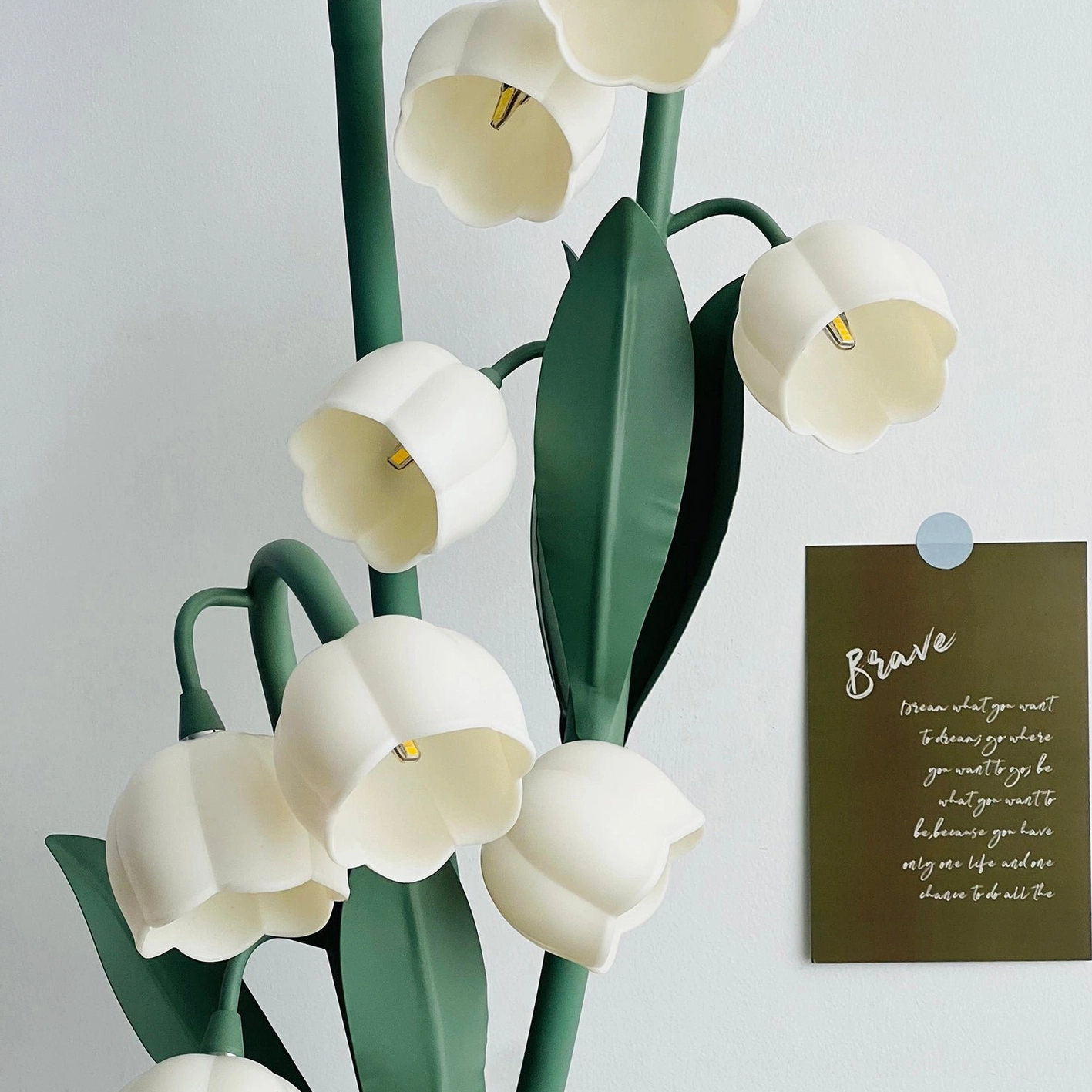 Modern floor lamp with green spiral stems showcasing nature-inspired design and sculptural aesthetic appeal