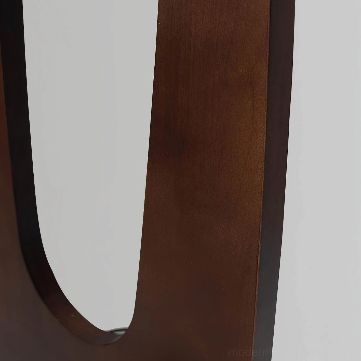Warm-toned solid oak floor lamp with frosted glass diffusers, softly illuminating residential interior