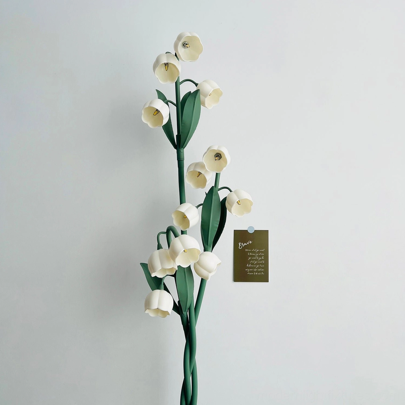 Three-light botanical floor lamp positioned in reading nook creating soft ambient illumination for relaxation