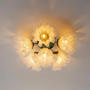 Close-up overhead view of floral ceiling light fixture with warm ambient glow illuminating ruffled acrylic glass shades
