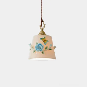 Handpainted floral ceramic pendant light with vintage brass hardware, featuring intricate rose and butterfly botanical design on cream-colored shade, close-up studio view