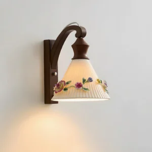 Detailed side view of botanical wall sconce showing pleated floral ceramic shade and natural wood arm
