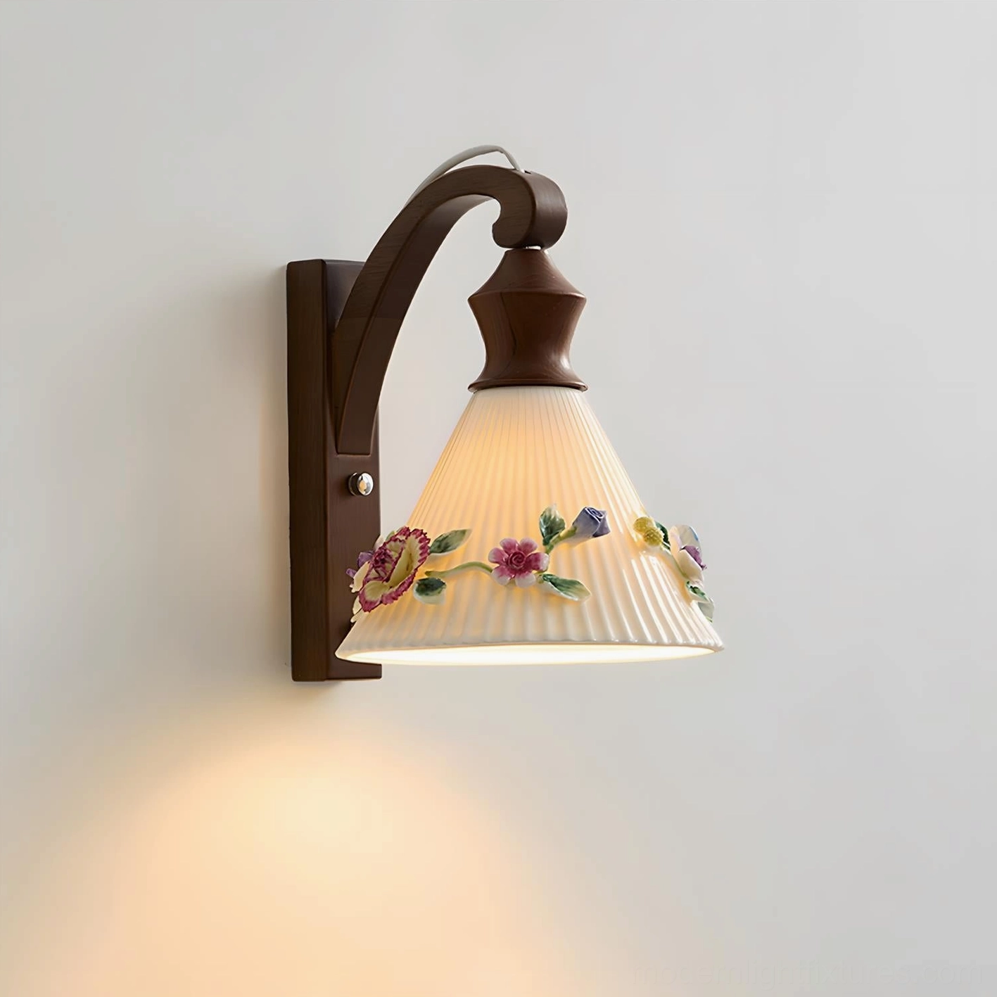 Detailed side view of botanical wall sconce showing pleated floral ceramic shade and natural wood arm