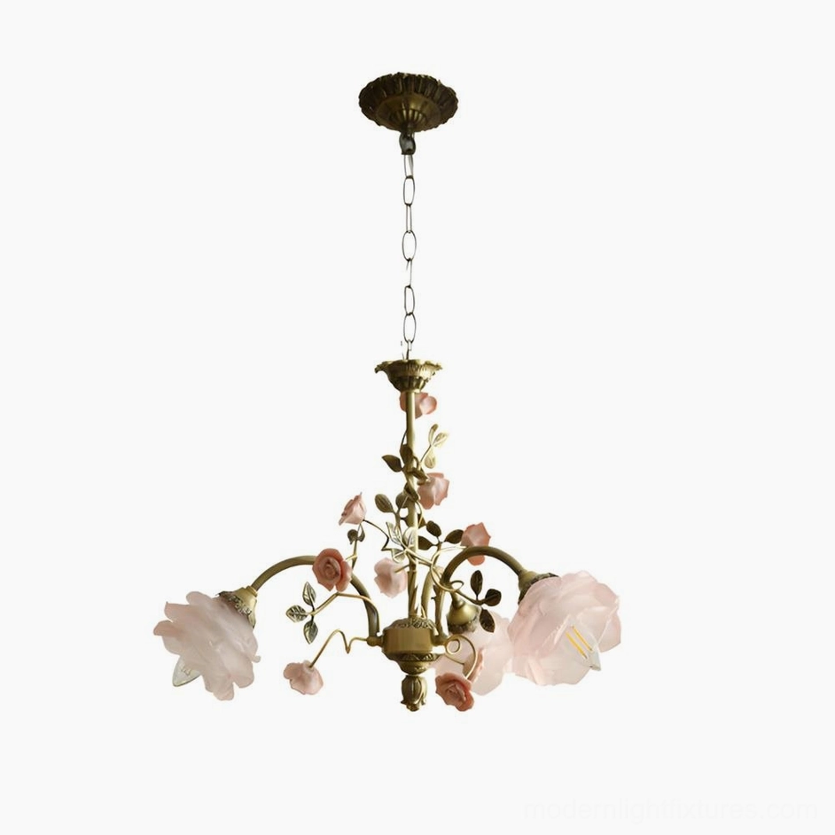 Antique brass floral chandelier bottom overhead detail view on white background showing pink flower accents and bronze frame construction