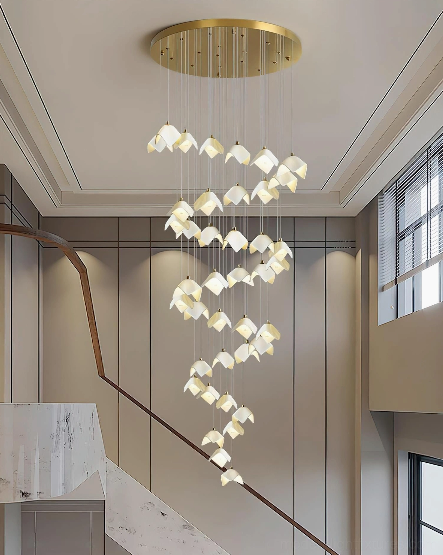 Side view of cascading bloom pendant light fixture in high-ceiling residential staircase with sleek modern design